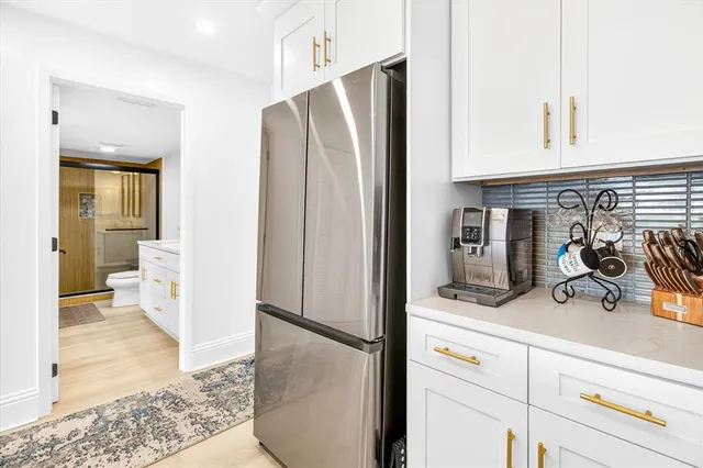 a kitchen with stainless steel appliances a refrigerator and cabinets