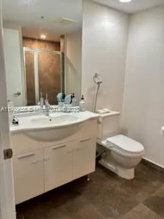 a bathroom with a sink a toilet and mirror