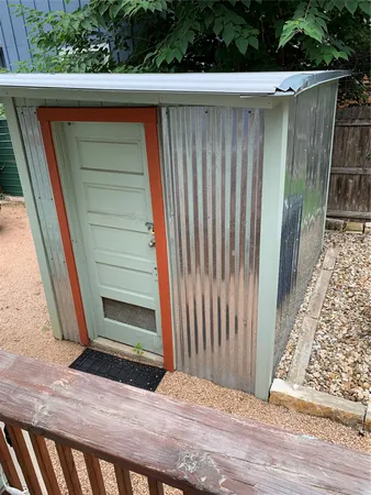 a wooden door view with a backyard