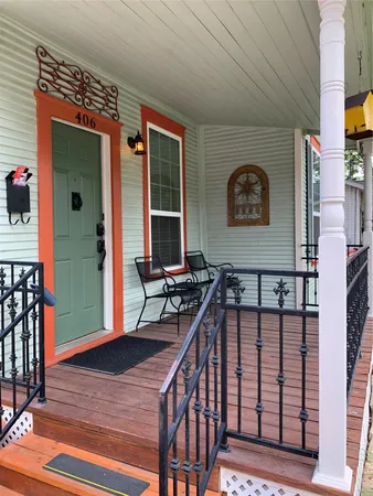 a view of a porch with furniture and a gate