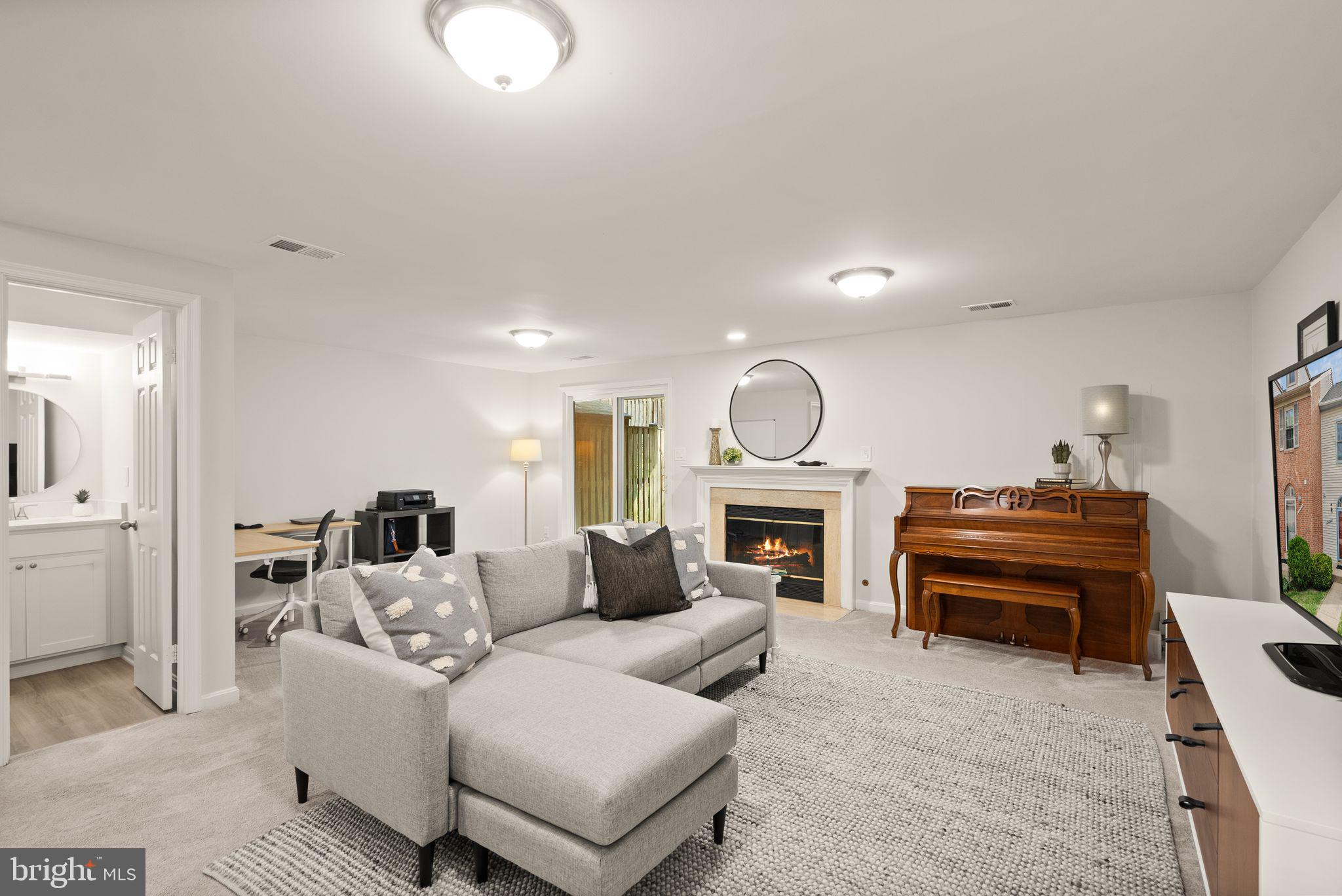 6369 English Ivy Way Springfield, VA 22152 - Photo 25 of 62 a living room with furniture and a fireplace