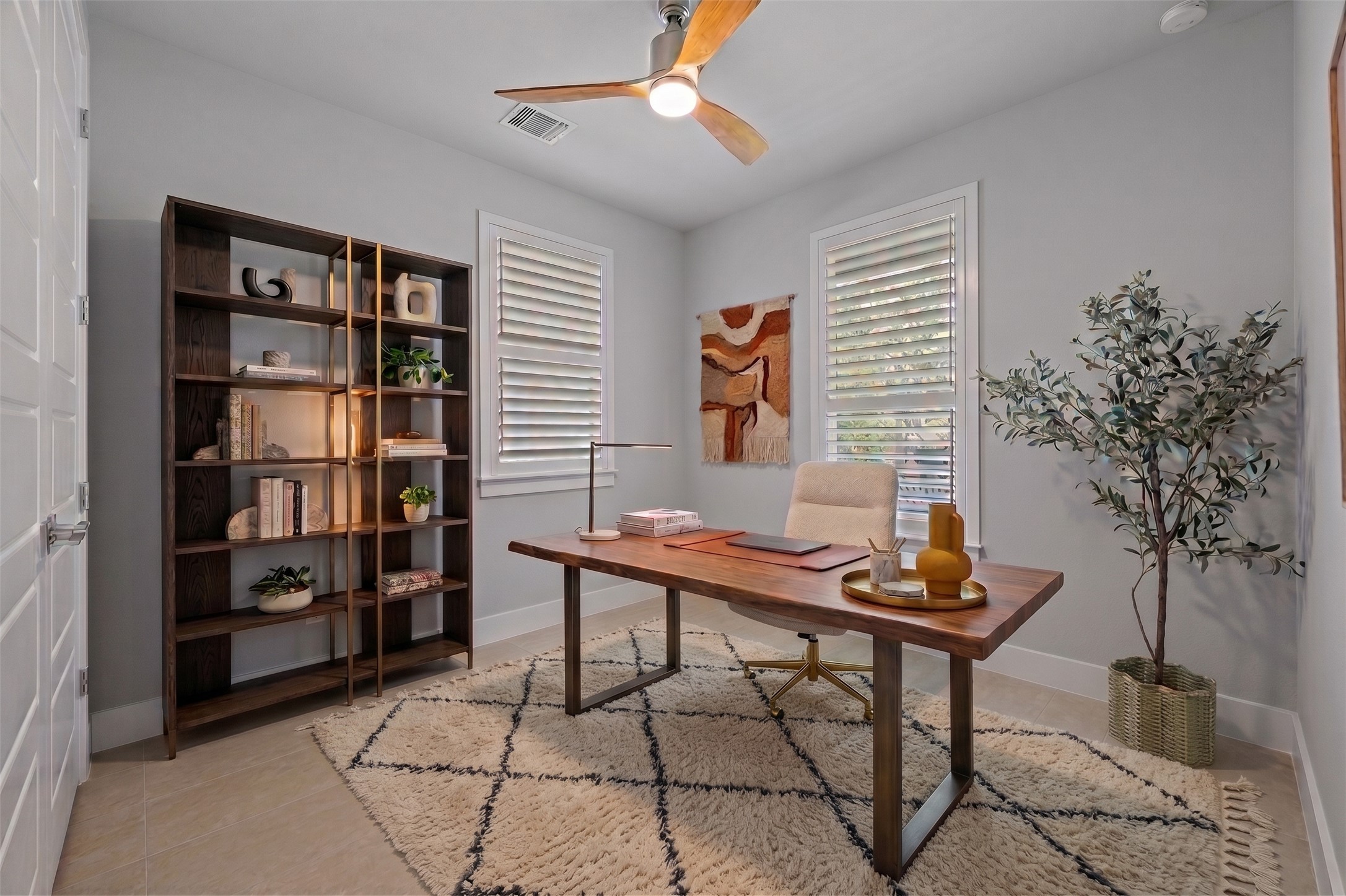 4515 Unity Circle Austin, TX 78731 - Photo 5 of 37 Double windows frame this quiet home workspace with smooth tiled flooring.