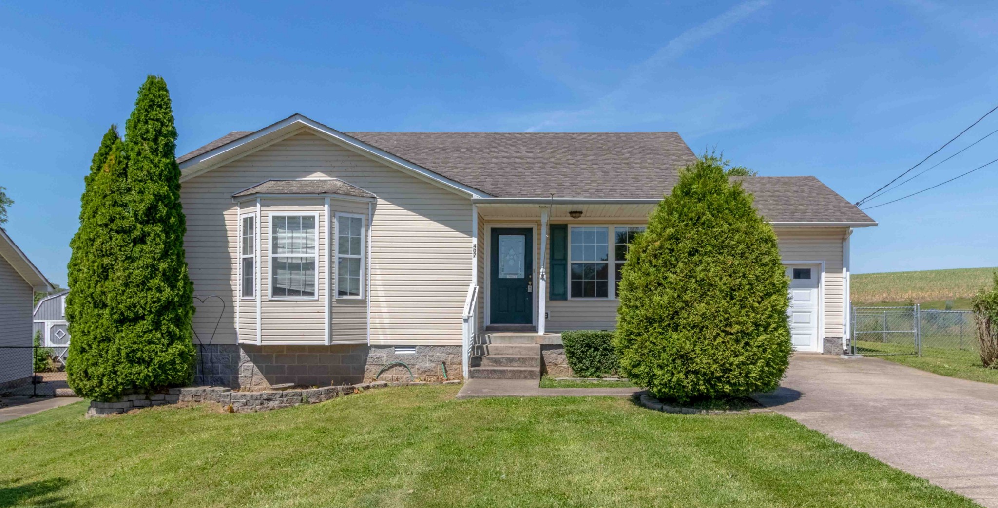407 Filmore Road Oak Grove, KY 42262 - Photo 1 of 25 a front view of a house with a yard
