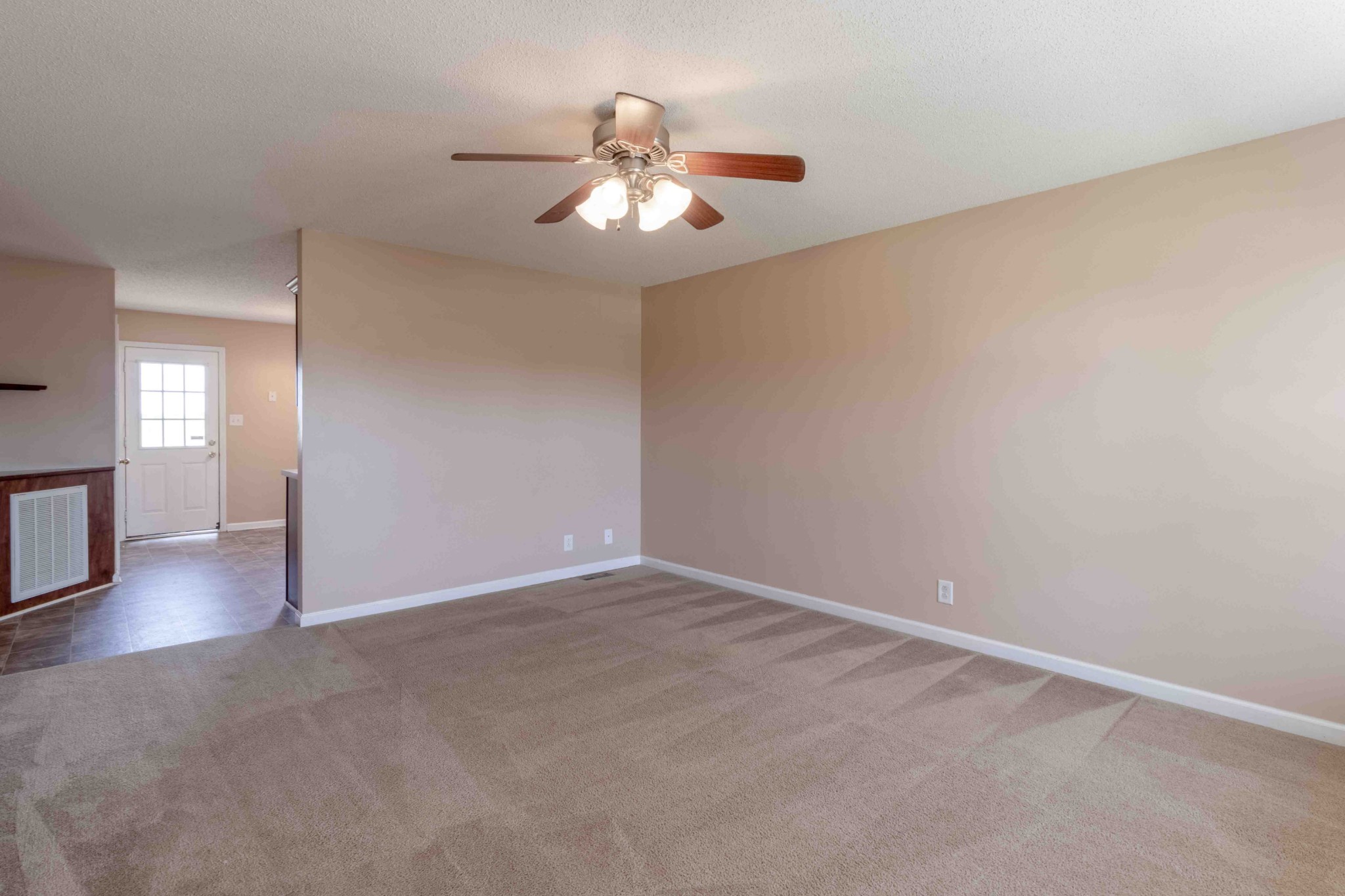 407 Filmore Road Oak Grove, KY 42262 - Photo 7 of 25 an empty room with wooden floor chandelier fan and windows