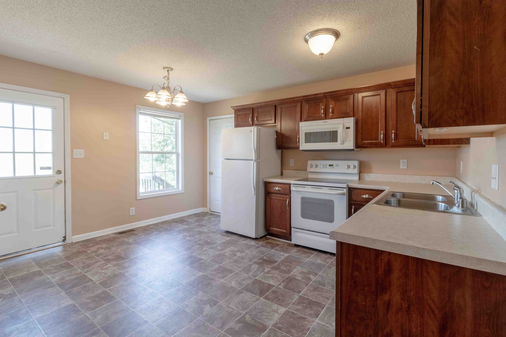 407 Filmore Road Oak Grove, KY 42262 - Photo 9 of 25 a kitchen with a stove a sink and a refrigerator