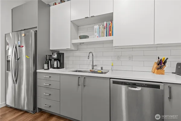 a kitchen with stainless steel appliances a sink and cabinets