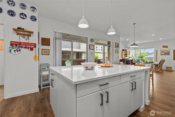 a kitchen with a sink and wooden floor