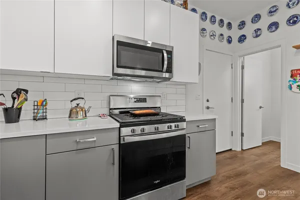 a kitchen with stainless steel appliances a stove a microwave and cabinets