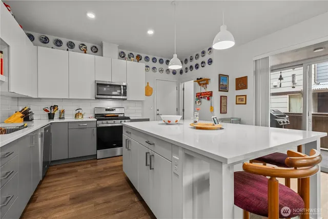 a kitchen that has a lot of cabinets a sink and a stove in it