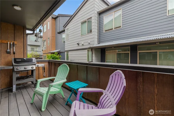 a balcony with table and chairs