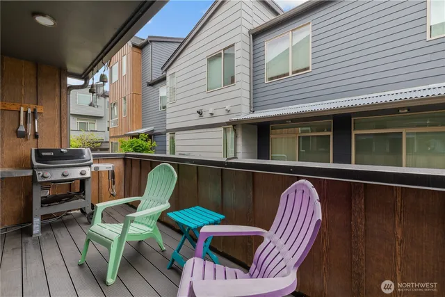 a balcony with table and chairs