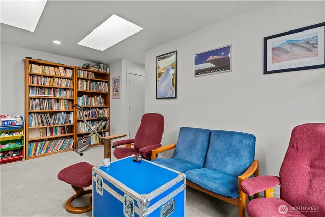 a living room with furniture and a book shelf