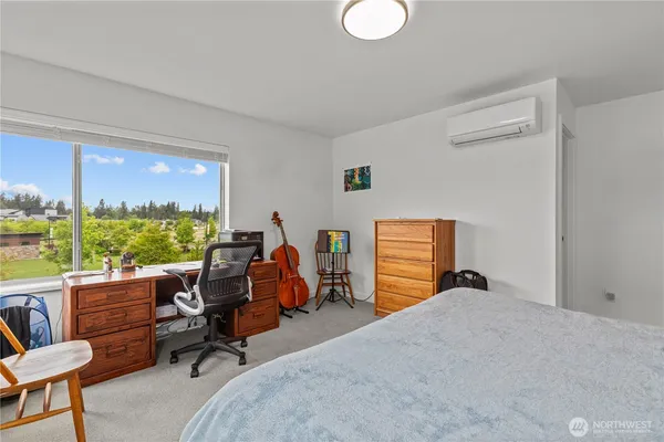a bedroom with furniture and a large window