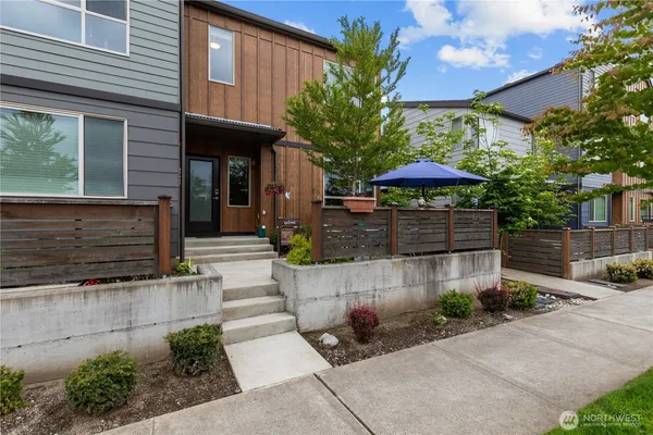 a front view of a house with plants