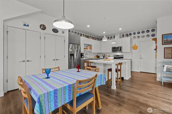 a kitchen that has a table chairs and a refrigerator