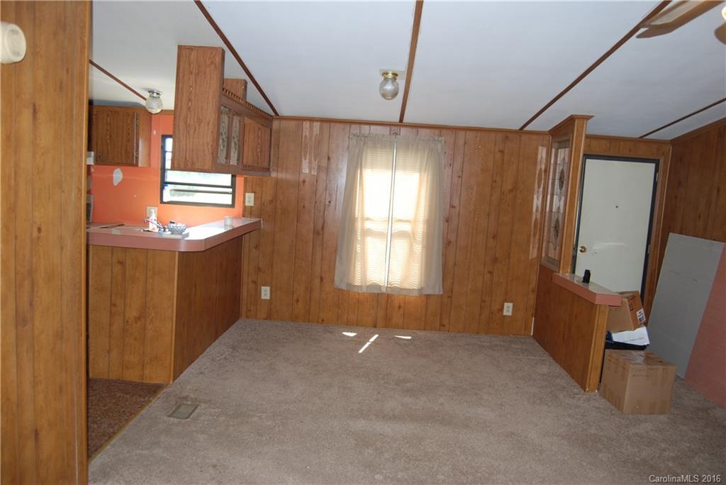 3224 Belk Mill Road Wingate, NC 28174 - Photo 4 of 13 a view of an empty room with a fireplace and a window