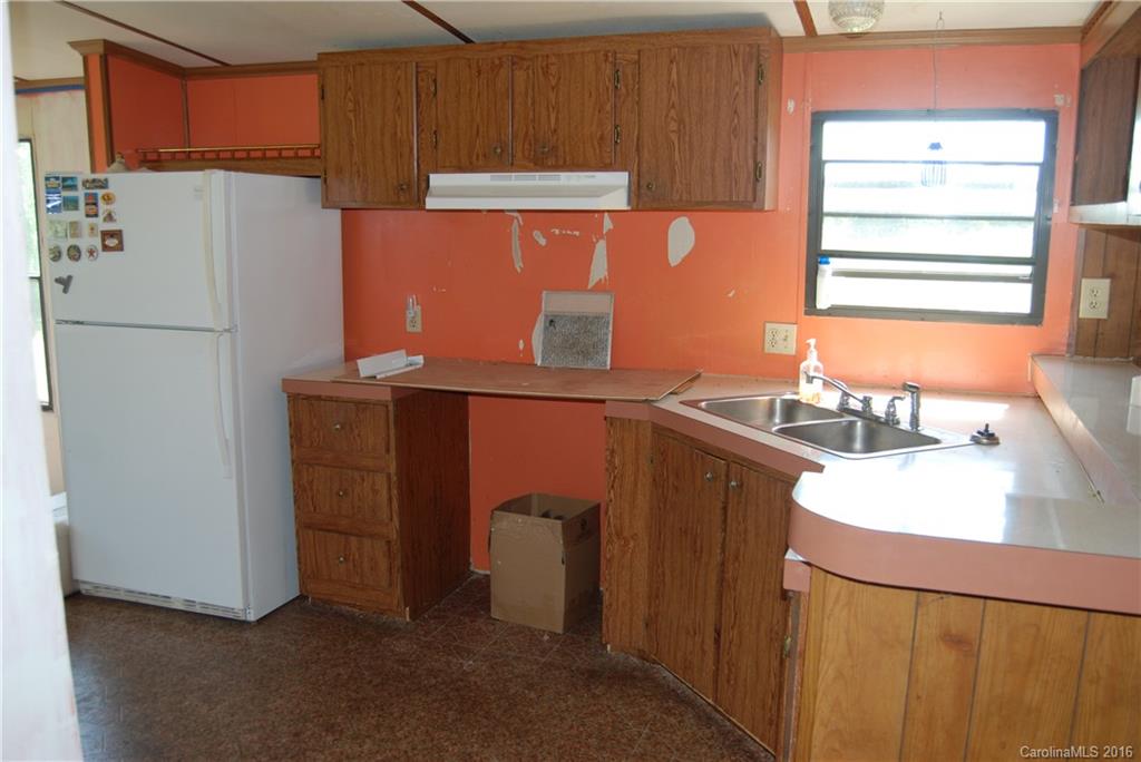 3224 Belk Mill Road Wingate, NC 28174 - Photo 7 of 13 a kitchen with stainless steel appliances granite countertop a refrigerator a sink and a stove