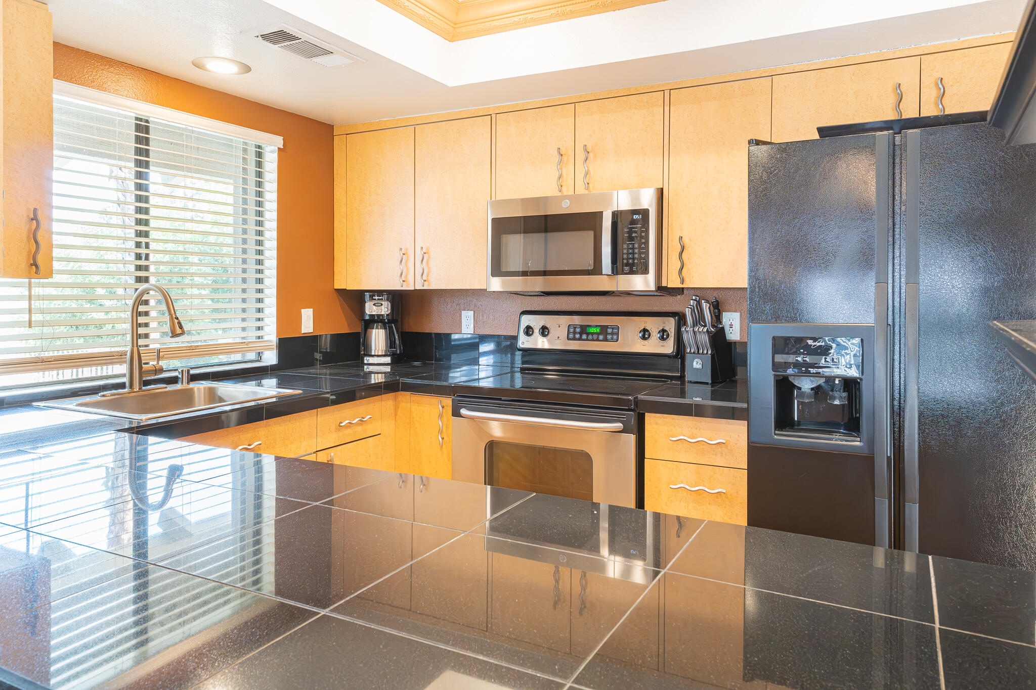 46631 Arapahoe, Unit B Indian Wells, CA 92210 - Photo 11 of 32 a kitchen with stainless steel appliances granite countertop a refrigerator a stove and a sink with granite countertops
