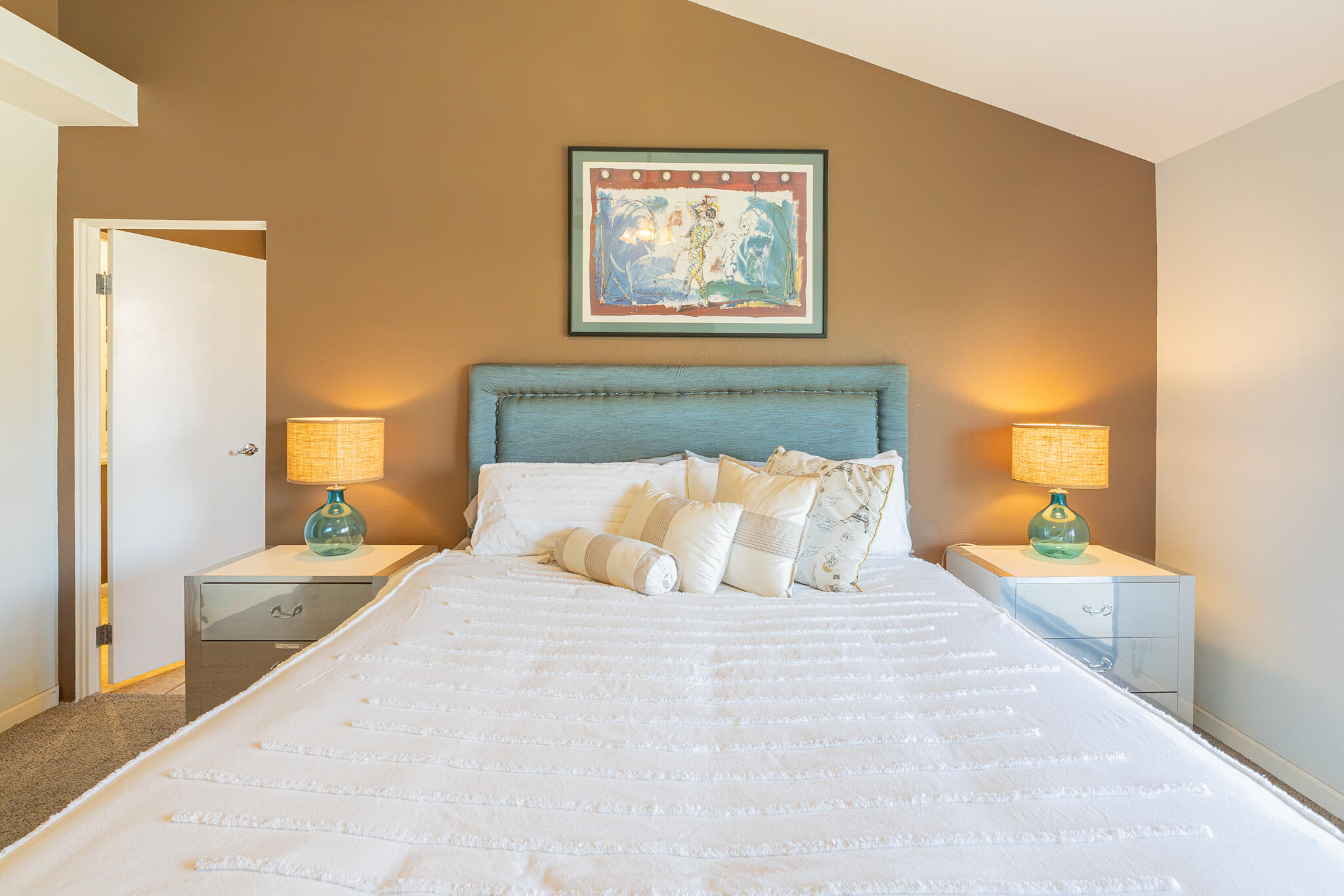 46631 Arapahoe, Unit B Indian Wells, CA 92210 - Photo 18 of 32 a bedroom with a bed and a painting on the wall