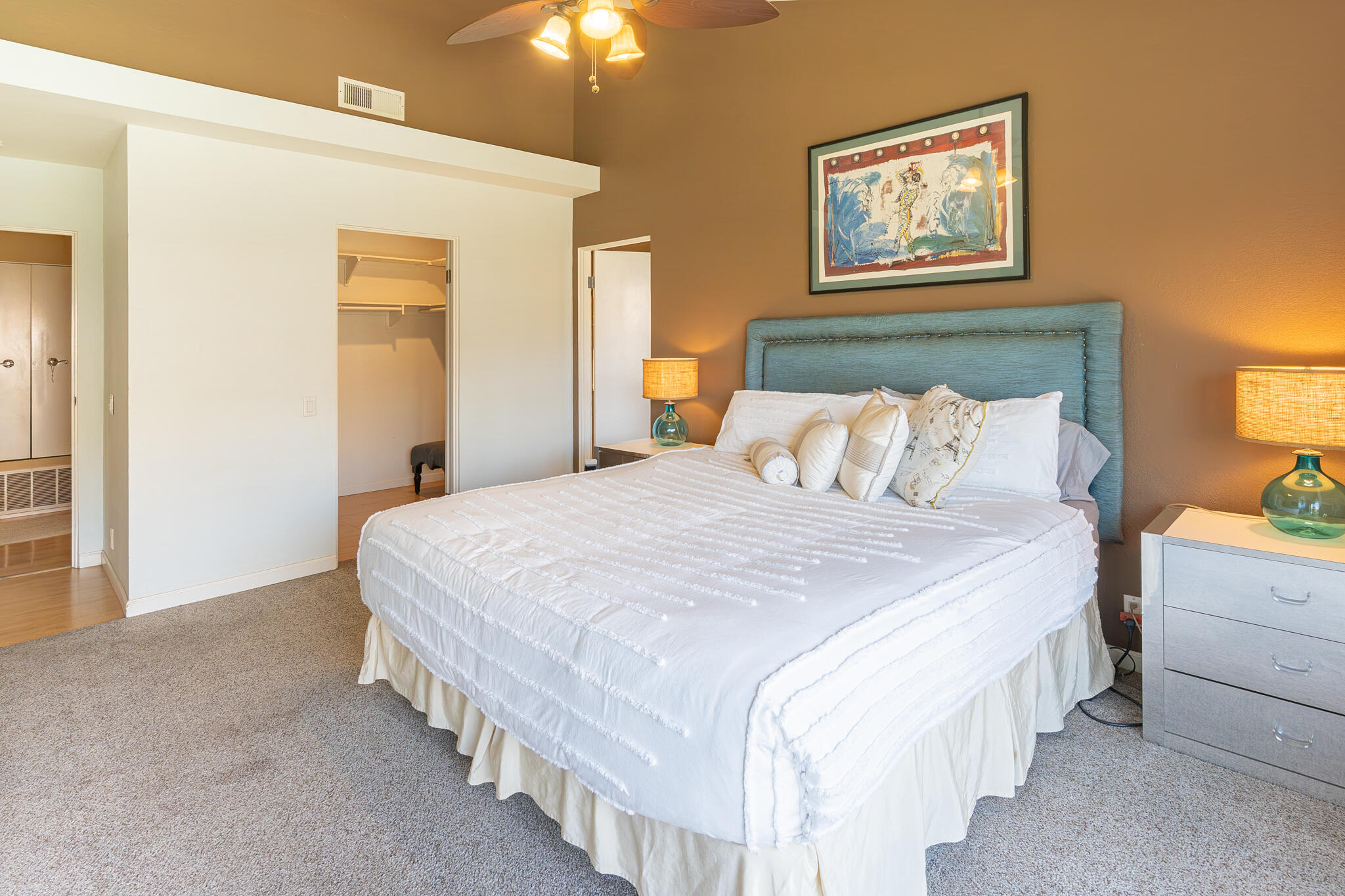 46631 Arapahoe, Unit B Indian Wells, CA 92210 - Photo 20 of 32 a bedroom with bed and paintings on the wall