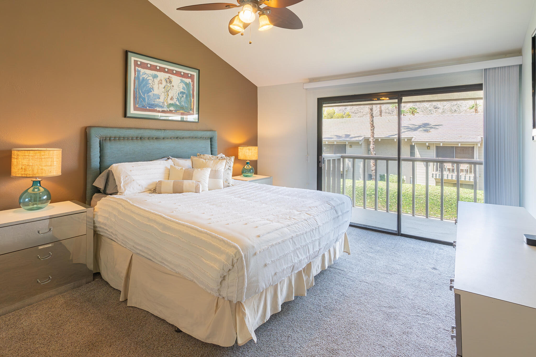 46631 Arapahoe, Unit B Indian Wells, CA 92210 - Photo 21 of 32 a spacious bedroom with a bed and a chandelier