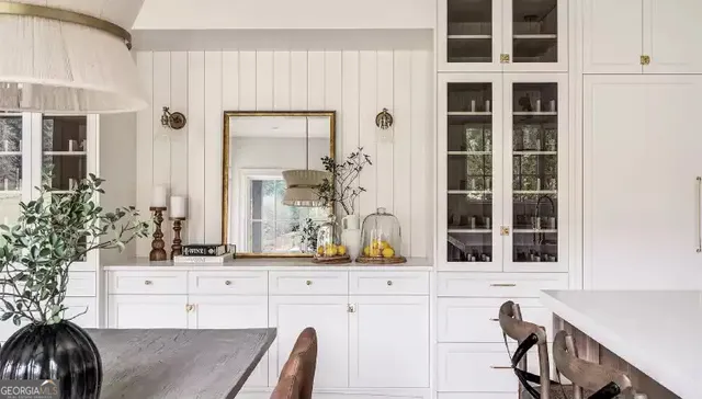 a large bed sitting in a bedroom next to a large window