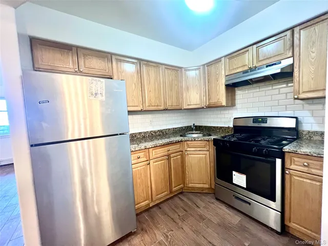a white refrigerator freezer sitting inside of a kitchen