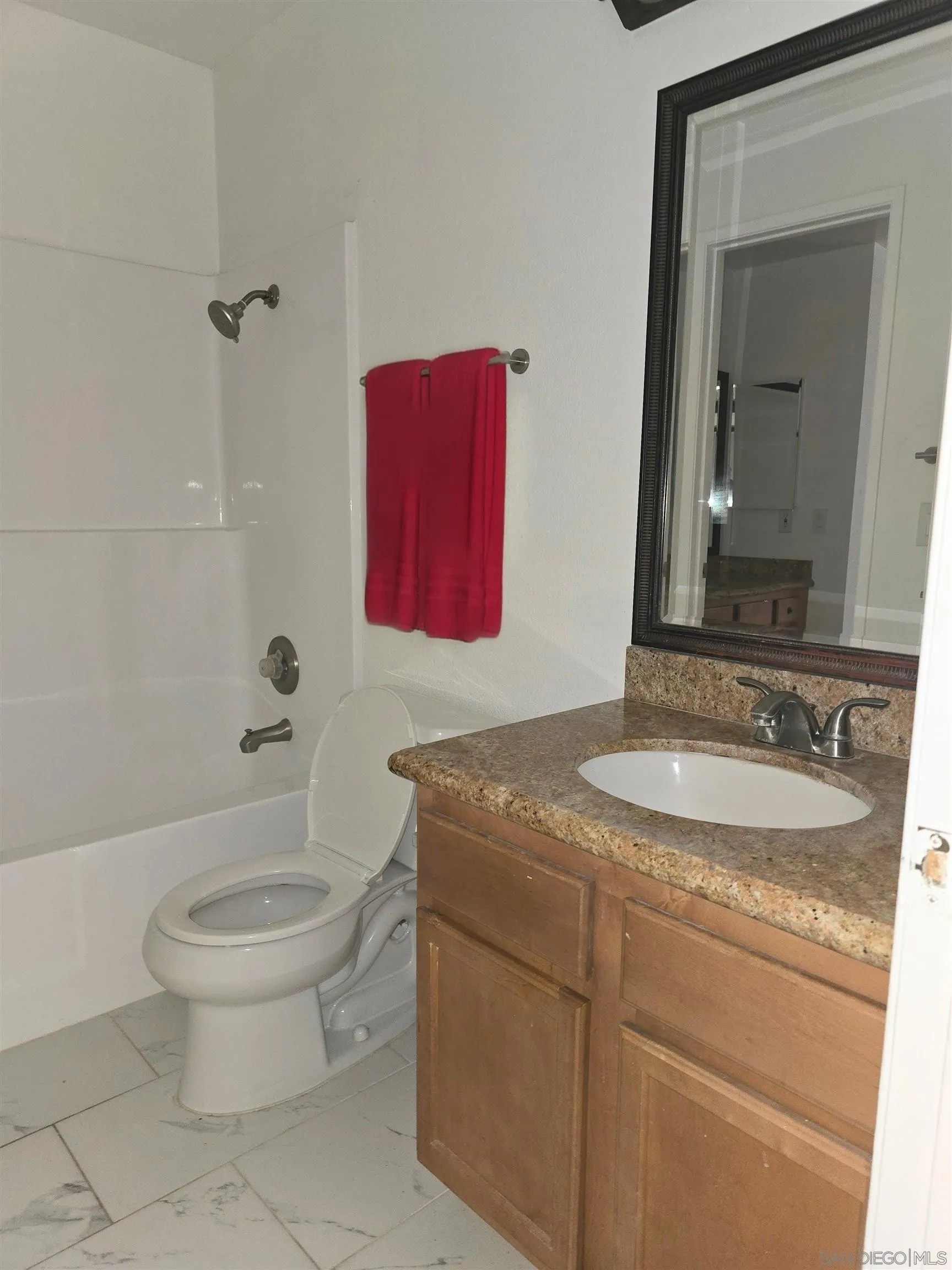 1130 West Blaine Street, Unit 204 Riverside, CA 92507 - Photo 11 of 24 a bathroom with a granite countertop toilet sink and mirror