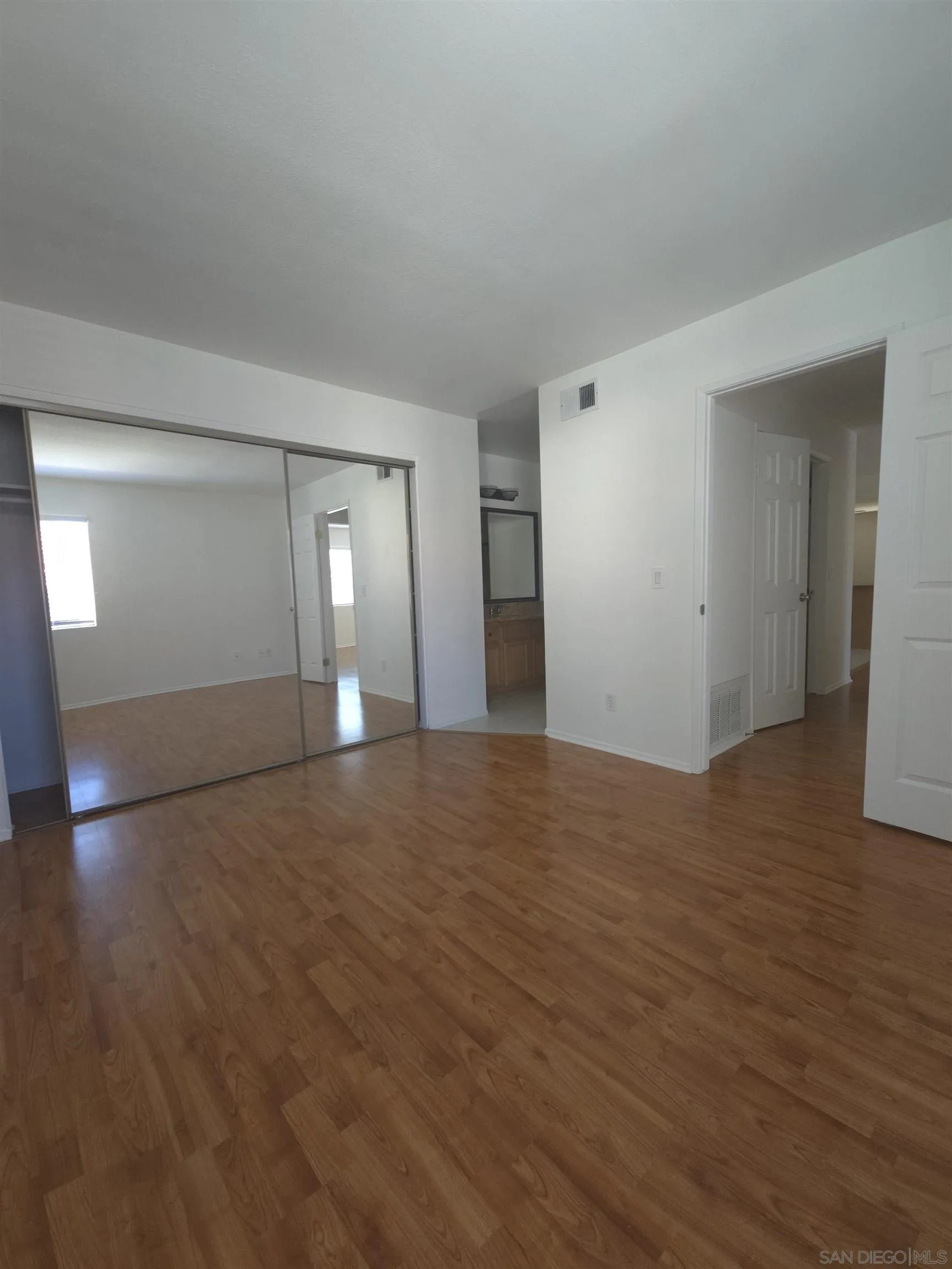 1130 West Blaine Street, Unit 204 Riverside, CA 92507 - Photo 14 of 24 a view of empty room with wooden floor and fan