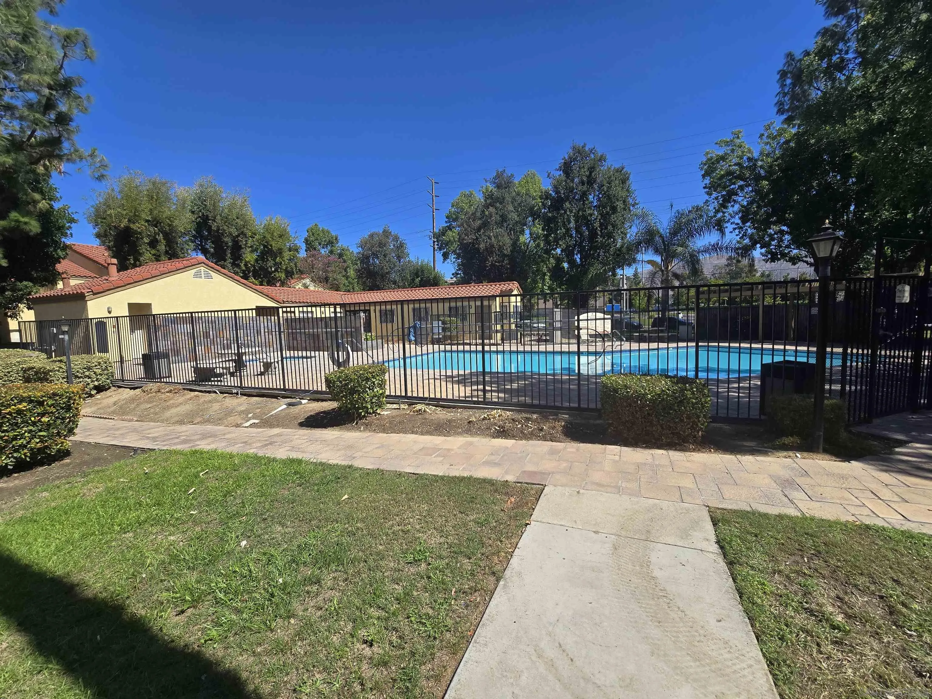 1130 West Blaine Street, Unit 204 Riverside, CA 92507 - Photo 18 of 24 a view of house with a garden and swimming pool