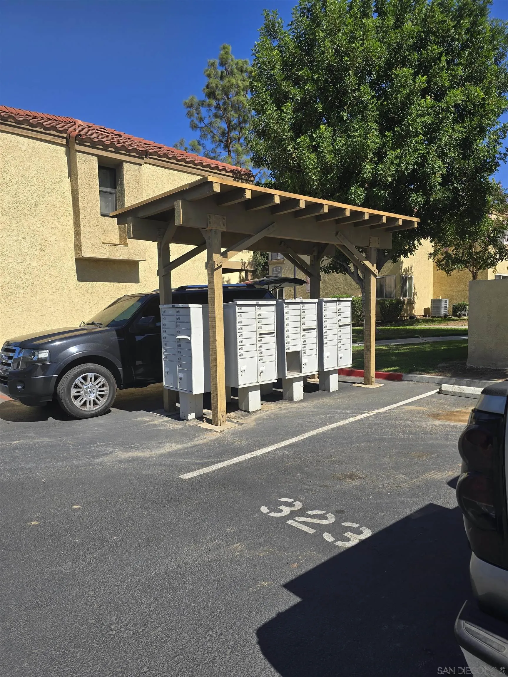 1130 West Blaine Street, Unit 204 Riverside, CA 92507 - Photo 21 of 24 a view of a car park in front of a house