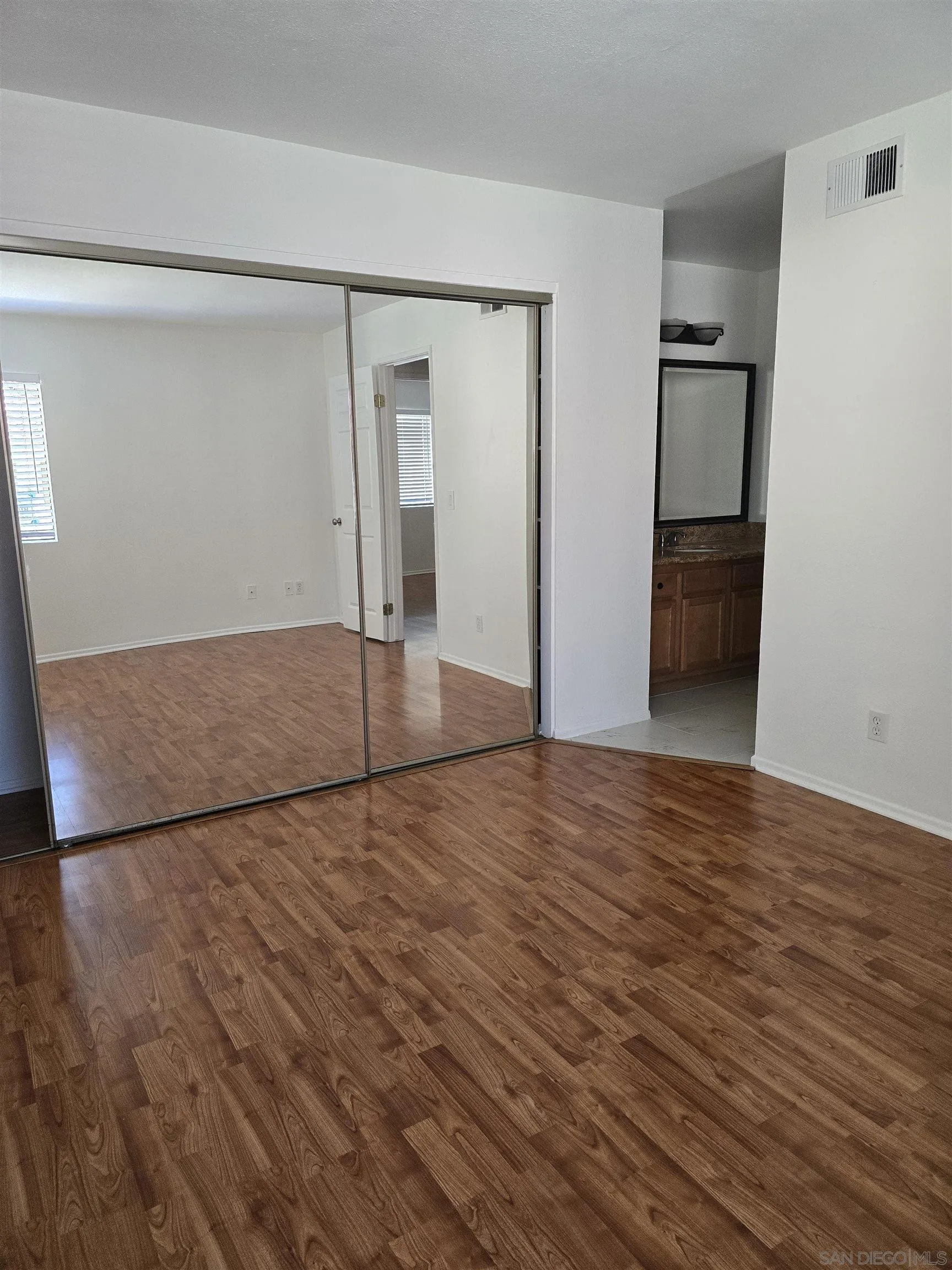 1130 West Blaine Street, Unit 204 Riverside, CA 92507 - Photo 22 of 24 a view of empty room with wooden floor and cabinet