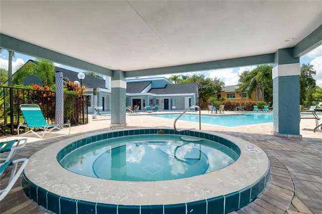 a swimming pool with outdoor seating and yard