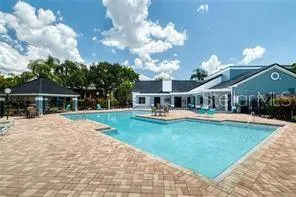 a front view of house with yard and swimming pool