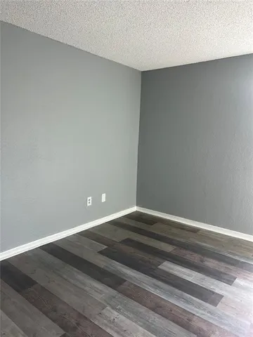 a view of room with wooden floor