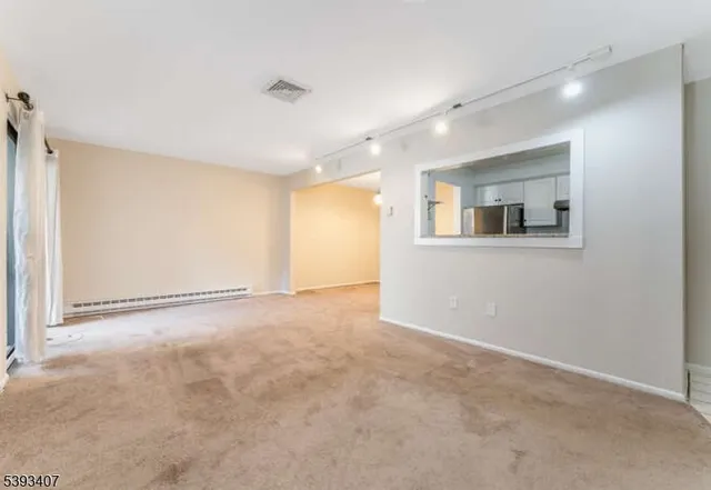 an empty room with a empty space and windows