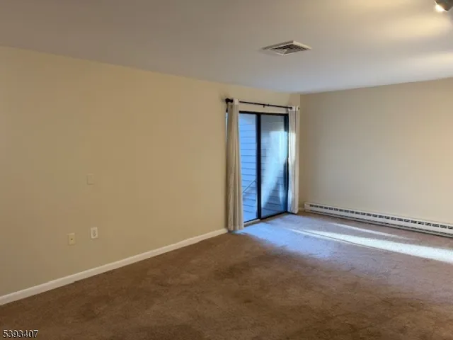 an empty room with closet and a chandelier fan