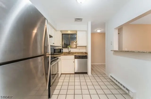 a kitchen with a refrigerator and a sink