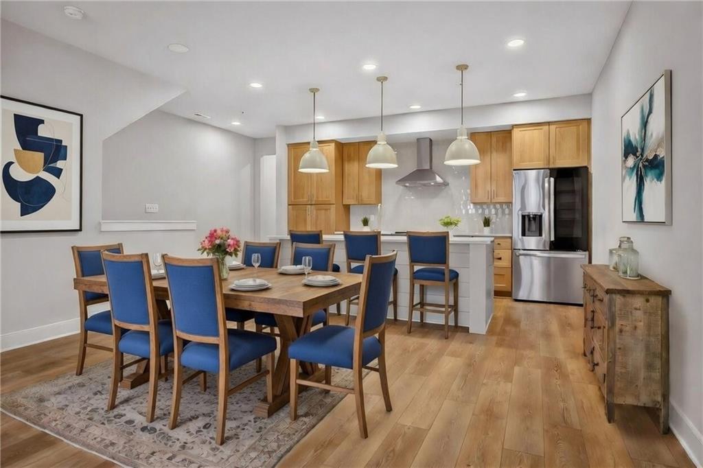 4022 Cottage Way Bridgeville, PA 15017 - Photo 11 of 47 a dining room with stainless steel appliances kitchen island granite countertop a table chairs and a refrigerator