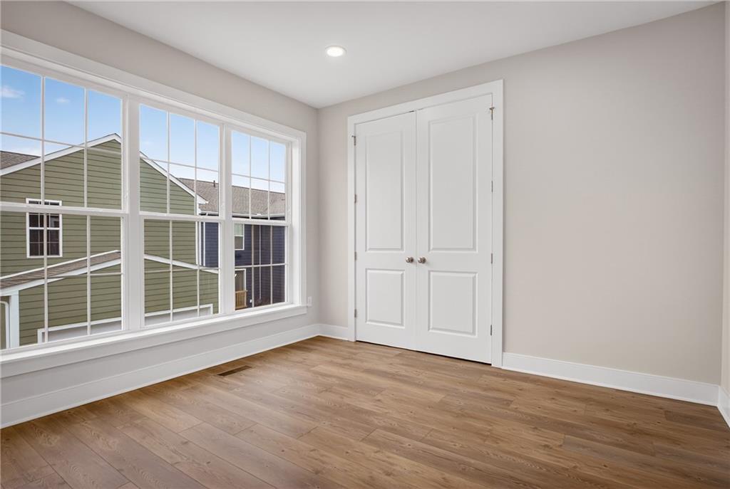 4022 Cottage Way Bridgeville, PA 15017 - Photo 18 of 47 a view of an empty room with wooden floor and windows