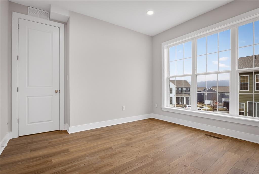4022 Cottage Way Bridgeville, PA 15017 - Photo 19 of 47 an empty room with wooden floor and windows