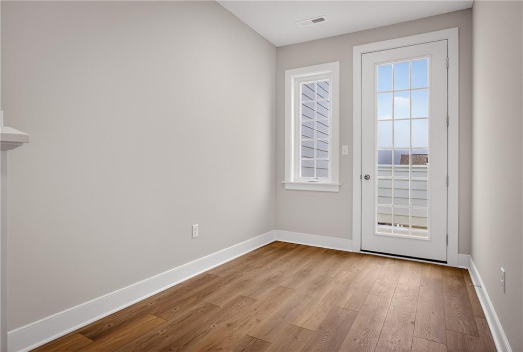 4022 Cottage Way Bridgeville, PA 15017 - Photo 24 of 47 an empty room with wooden floor and windows