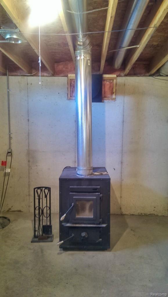 7784 West Lange Road Fowlerville, MI 48836 - Photo 27 of 28 woodburner connected to ductwork