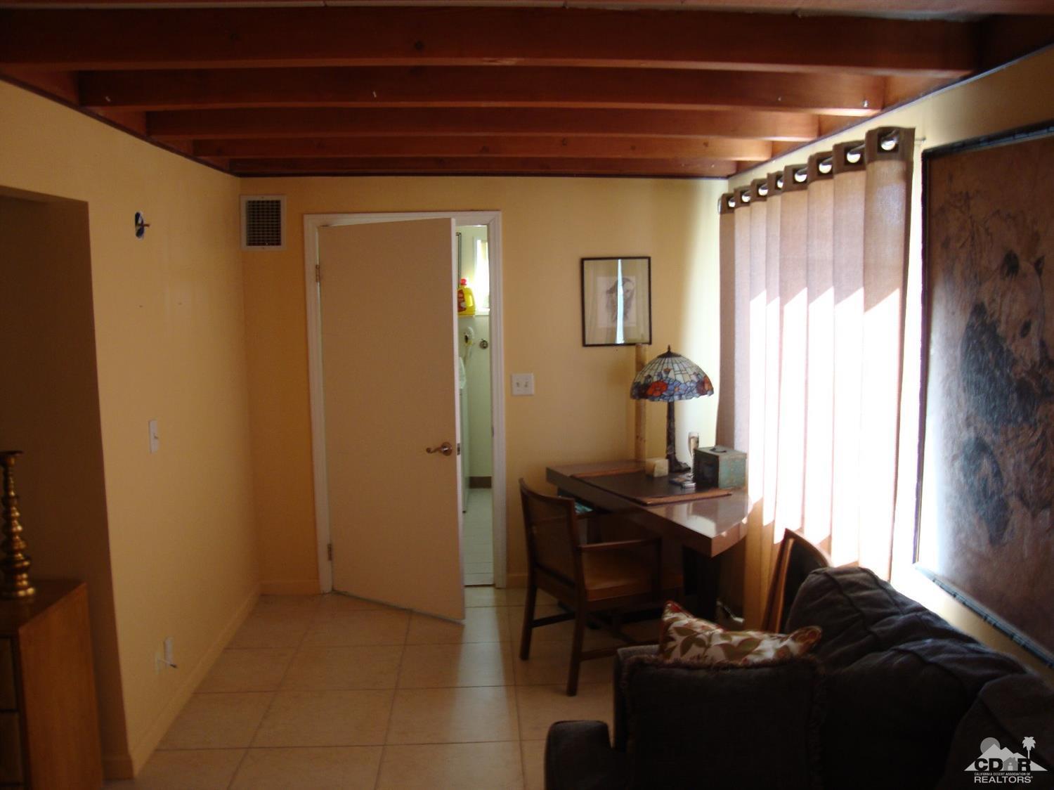 66671 San Rafael Road Desert Hot Springs, CA 92240 - Photo 13 of 36 a living room with furniture and a window
