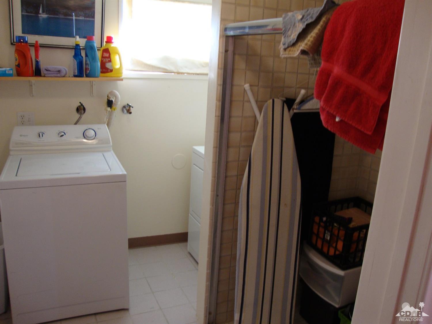 66671 San Rafael Road Desert Hot Springs, CA 92240 - Photo 14 of 36 a view of walk in closet with clothes and shoes