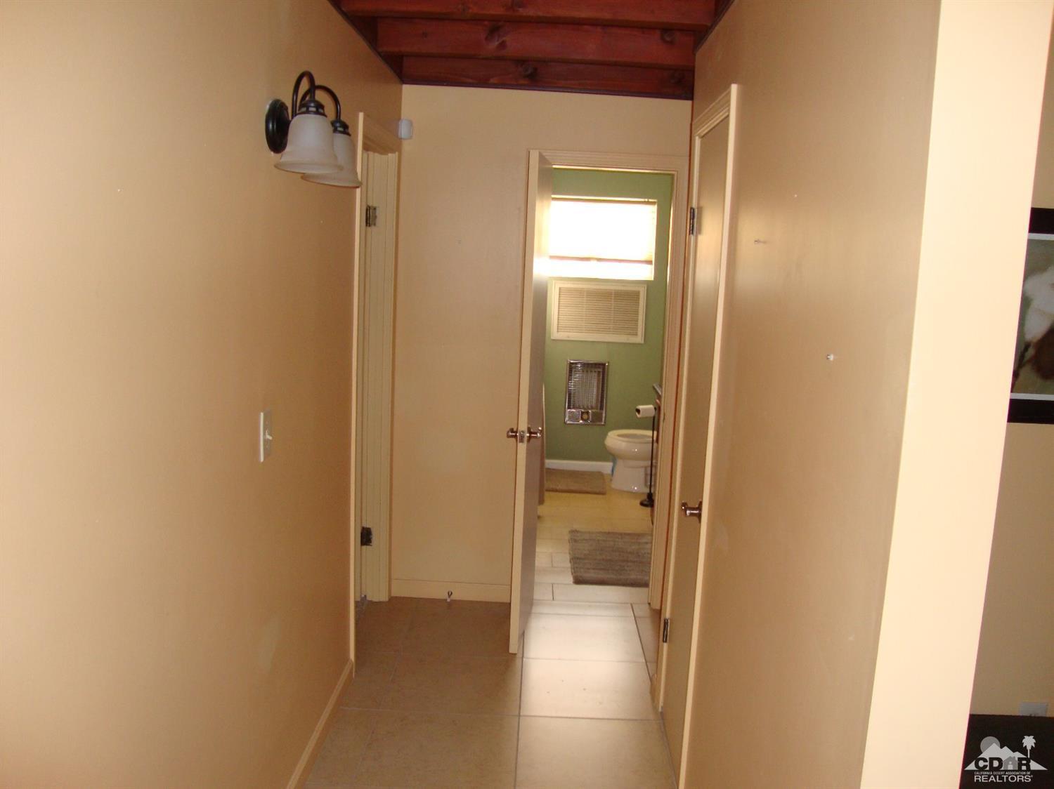 66671 San Rafael Road Desert Hot Springs, CA 92240 - Photo 16 of 36 a view of a bathroom from a hallway