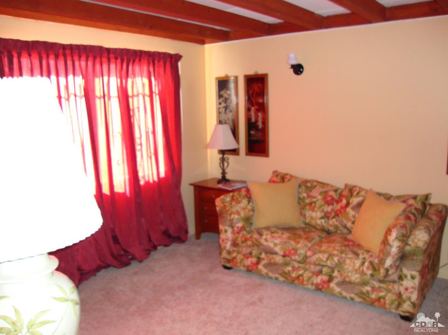 66671 San Rafael Road Desert Hot Springs, CA 92240 - Photo 18 of 36 a living room with furniture and a window