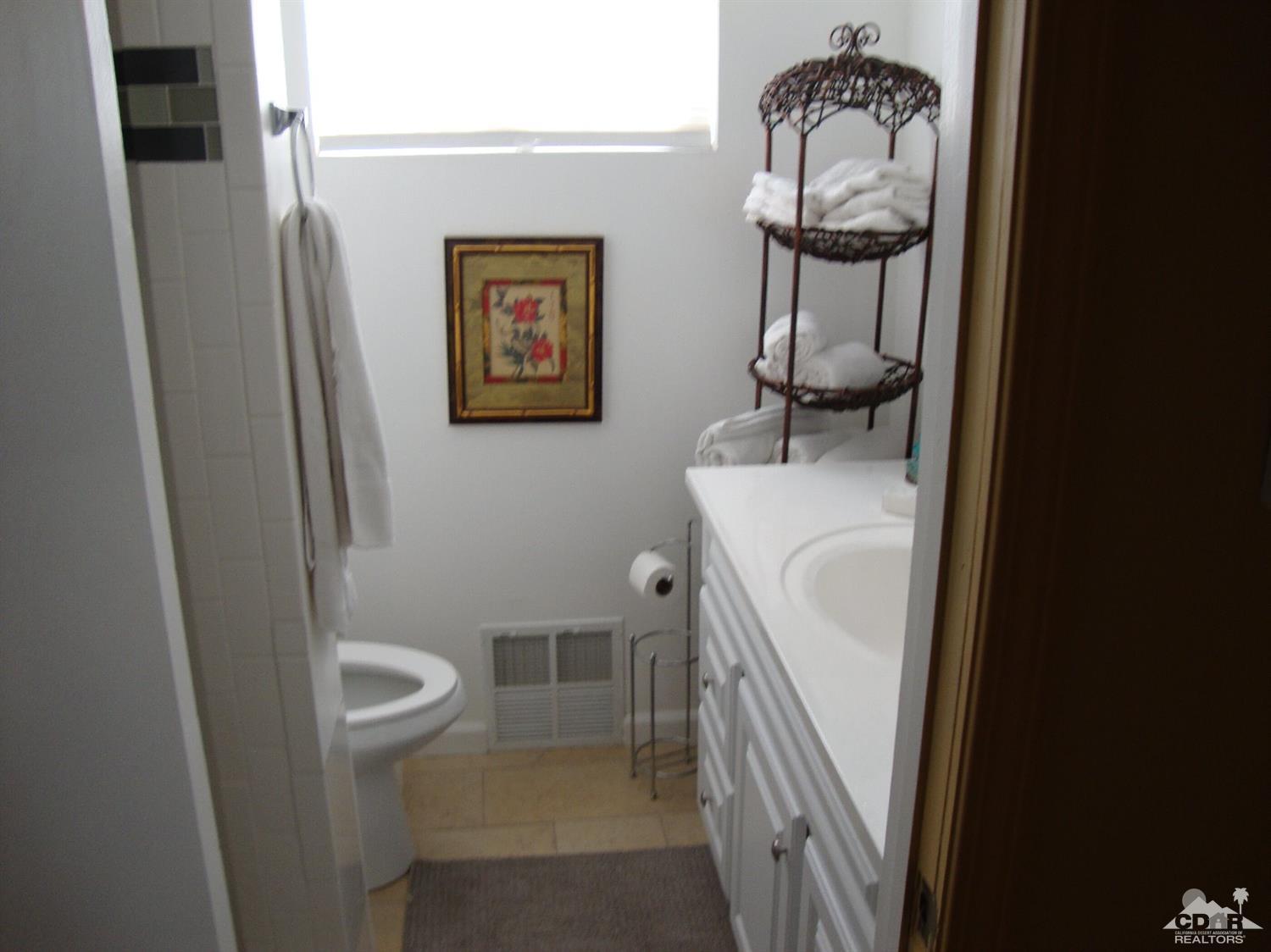 66671 San Rafael Road Desert Hot Springs, CA 92240 - Photo 21 of 36 a bathroom with a toilet and a sink