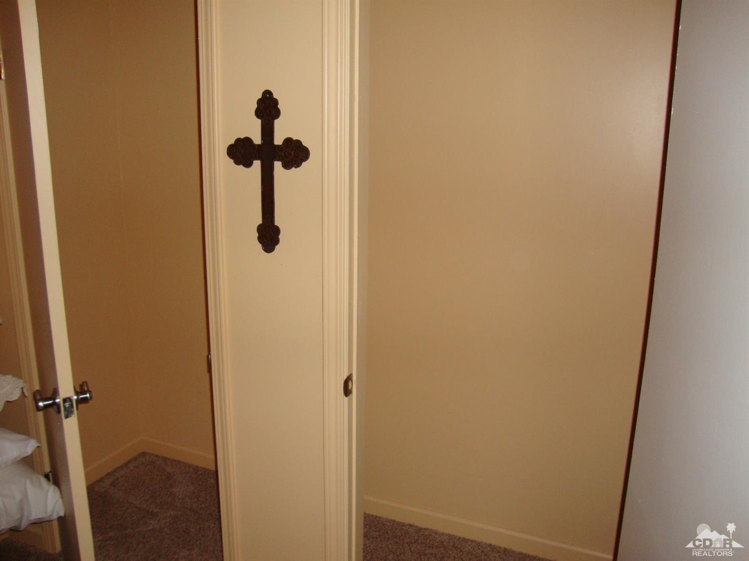 66671 San Rafael Road Desert Hot Springs, CA 92240 - Photo 23 of 36 a bathroom with a glass door
