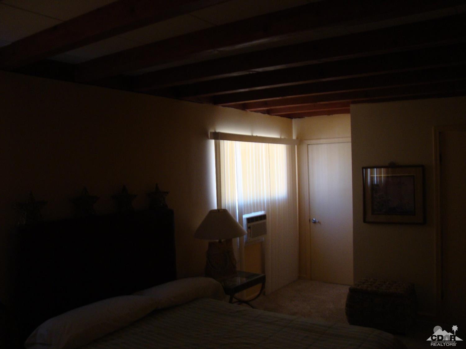 66671 San Rafael Road Desert Hot Springs, CA 92240 - Photo 24 of 36 a view of entryway and hall with wooden floor